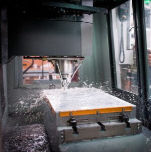 Knife factory worker monitoring machinery in workshop